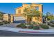 Beautiful two-story home with desert landscaping, a paved brick driveway, and a two-car garage at 7702 Wishbone Falls St, North Las Vegas, NV 89084