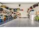 Spacious two car garage featuring epoxy floors and ample wall and ceiling storage at 7702 Wishbone Falls St, North Las Vegas, NV 89084