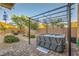 Backyard hot tub on a brick patio with pergola, surrounded by a landscaped yard and privacy fence at 7702 Wishbone Falls St, North Las Vegas, NV 89084