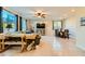 Bright and airy living room with tile flooring, modern furniture, and natural light from large windows at 7702 Wishbone Falls St, North Las Vegas, NV 89084