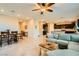 Open-concept living area with tile floors, a comfortable couch, and seamless access to the dining and kitchen areas at 7702 Wishbone Falls St, North Las Vegas, NV 89084