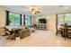 Spacious living room featuring tile floors, plenty of natural light, and modern, comfortable furnishings at 7702 Wishbone Falls St, North Las Vegas, NV 89084