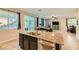 Bright kitchen with large granite island seamlessly connects to the dining and living areas at 7702 Wishbone Falls St, North Las Vegas, NV 89084