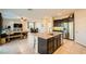 Open floor plan featuring a kitchen island, stainless steel appliances, and seamless access to dining and living areas at 7702 Wishbone Falls St, North Las Vegas, NV 89084