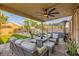 Relaxing covered patio featuring comfortable seating, ceiling fan, heater, and a view of the backyard at 7702 Wishbone Falls St, North Las Vegas, NV 89084