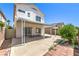 Backyard featuring a covered patio, mature trees, and partial brick paver accents at 7977 Blue Brook Dr, Las Vegas, NV 89147