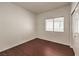 This bedroom is bright, featuring modern wood floors and a window with pleasant views at 7977 Blue Brook Dr, Las Vegas, NV 89147