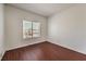 This cozy bedroom features a window letting in natural light and stylish wood flooring at 7977 Blue Brook Dr, Las Vegas, NV 89147