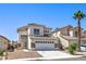 Charming two-story home with a tile roof and stone accents, plus a two-car garage and low-maintenance landscaping at 7977 Blue Brook Dr, Las Vegas, NV 89147