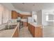A bright kitchen featuring an island, stainless steel appliances, tile flooring and plenty of counter space at 7977 Blue Brook Dr, Las Vegas, NV 89147