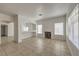 Bright living room with breakfast bar, modern fireplace, and large windows at 7977 Blue Brook Dr, Las Vegas, NV 89147