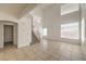Bright, open living room with tile flooring, high ceilings, and staircase with wood railing at 7977 Blue Brook Dr, Las Vegas, NV 89147
