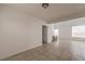 Bright, open living room with tile flooring, high ceilings, and access to the staircase at 7977 Blue Brook Dr, Las Vegas, NV 89147