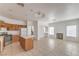 Open floor plan showcasing kitchen with an island, breakfast bar, and fireplace at 7977 Blue Brook Dr, Las Vegas, NV 89147