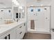 Bright bathroom with double sinks, modern fixtures, and a glass-enclosed shower at 8055 Haywood Estate Ave, Las Vegas, NV 89113