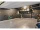 Spacious garage featuring a clean, speckled epoxy floor and storage racks, with charger and door to house at 8055 Haywood Estate Ave, Las Vegas, NV 89113