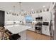 Modern kitchen boasts white cabinets, stainless steel appliances, and a large central island at 8055 Haywood Estate Ave, Las Vegas, NV 89113