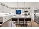 Bright and modern kitchen featuring white cabinets, stainless steel appliances, and a large island at 8055 Haywood Estate Ave, Las Vegas, NV 89113