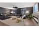 Spacious living room featuring a large sectional sofa, contemporary ceiling fan, and decorative fireplace at 8055 Haywood Estate Ave, Las Vegas, NV 89113