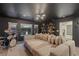Spacious living room featuring a large sectional, drum set, backyard views and stylish shelves, perfect for entertaining at 8055 Haywood Estate Ave, Las Vegas, NV 89113