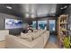 Cozy living room with a large sectional, a drum set, modern lighting, and backyard views, creating a versatile space at 8055 Haywood Estate Ave, Las Vegas, NV 89113