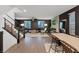 Spacious living room with staircase access, wood flooring, fireplace, and ample seating at 8055 Haywood Estate Ave, Las Vegas, NV 89113