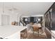 View of the open-concept kitchen, stairs, and living area with modern finishes and lighting at 8055 Haywood Estate Ave, Las Vegas, NV 89113