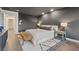Tastefully designed bedroom with a king bed, wood floors, and dark grey accent wall at 8055 Haywood Estate Ave, Las Vegas, NV 89113