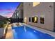 Backyard swimming pool with seating, fire pit, outdoor lighting, and modern architectural details, perfect for entertainment at 8055 Haywood Estate Ave, Las Vegas, NV 89113