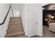 Modern staircase with wood steps and black railings, leading to the upper level at 8055 Haywood Estate Ave, Las Vegas, NV 89113
