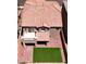 Aerial view of a tan-colored house with red brick patio and grassy backyard at 8131 Skye Plum St, Las Vegas, NV 89166