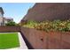 Red flowers along the retaining wall add a splash of color to the backyard at 8131 Skye Plum St, Las Vegas, NV 89166