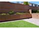 Green backyard with turf and flowerbeds in a landscaped area at 8131 Skye Plum St, Las Vegas, NV 89166