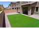 Green turf contrasts beautifully with the brick-lined backyard hardscape at 8131 Skye Plum St, Las Vegas, NV 89166