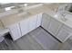 Bathroom with white cabinetry, white countertops, double sinks and wood-look tile at 8131 Skye Plum St, Las Vegas, NV 89166
