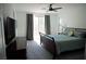 Bright bedroom featuring a ceiling fan, balcony access, and gray carpet flooring at 8131 Skye Plum St, Las Vegas, NV 89166