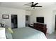 Bedroom featuring a ceiling fan, a walk-in closet and mounted TV at 8131 Skye Plum St, Las Vegas, NV 89166