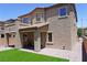 Outdoor patio with a seating area overlooking a green turf backyard at 8131 Skye Plum St, Las Vegas, NV 89166