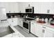 Updated kitchen with white cabinets, granite countertops, and stainless steel appliances at 8131 Skye Plum St, Las Vegas, NV 89166