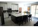 Open-concept kitchen with granite island, seating, and access to the backyard at 8131 Skye Plum St, Las Vegas, NV 89166