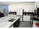 Well-lit kitchen with granite countertops, stainless steel appliances, and white cabinetry at 8131 Skye Plum St, Las Vegas, NV 89166