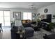 Comfortable living room with a gray sectional sofa, and sliding doors to backyard at 8131 Skye Plum St, Las Vegas, NV 89166