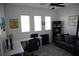 Functional office space with ample desk space, a comfortable sofa, and natural light at 8131 Skye Plum St, Las Vegas, NV 89166