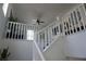 Bright staircase with white banister and high ceilings, leading to the upper level at 8131 Skye Plum St, Las Vegas, NV 89166