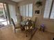 Charming breakfast nook featuring a glass-top table, classic chairs, and natural light streaming through the windows and sliding door at 8337 Ruby Heights Ave, Las Vegas, NV 89117