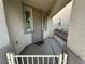 Cozy front porch featuring neutral stucco, decorative iron railing, and a tiled entryway at 8337 Ruby Heights Ave, Las Vegas, NV 89117