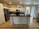 Well-lit kitchen with white cabinets, dark countertops, stainless steel appliances and a view of the breakfast nook at 8337 Ruby Heights Ave, Las Vegas, NV 89117
