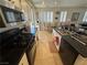 Spacious kitchen with dark appliances and countertops, white cabinets, and views of the dining area and sliding glass doors at 8337 Ruby Heights Ave, Las Vegas, NV 89117