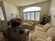 Bright living room with plush seating, stylish decor, and plenty of natural light from large windows at 8337 Ruby Heights Ave, Las Vegas, NV 89117