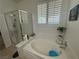 Modern bathroom featuring a glass-enclosed shower, separate soaking tub, and tile floors for a spa-like experience at 8337 Ruby Heights Ave, Las Vegas, NV 89117